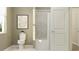 Simple bathroom with a toilet, tub, and neutral color palette at 290 Puma Loop, Groveland, FL 34736