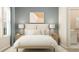 Main bedroom with a plush bed and neutral color palette at 290 Puma Loop, Groveland, FL 34736