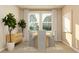 Bright dining room featuring a light wood table and gray chairs at 290 Puma Loop, Groveland, FL 34736