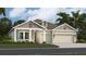 One-story home with gray siding, brown accents, and a two-car garage at 290 Puma Loop, Groveland, FL 34736