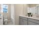 Double vanity bathroom with gray cabinets and white countertop at 5782 Meditation Dr, Clermont, FL 34714