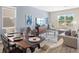 Living room features a gray sectional sofa and a large window at 5782 Meditation Dr, Clermont, FL 34714