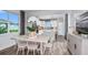 Bright dining area with light wood table and chairs, adjacent to kitchen at 5879 Sw 87Th Ave, Ocala, FL 34481