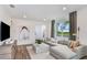 Living room with L-shaped sectional sofa, large windows, and hardwood floors at 5879 Sw 87Th Ave, Ocala, FL 34481