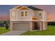 Two-story house with gray siding, orange accents, and a two-car garage at 3468 Dahlia Dr, Lake Hamilton, FL 33851