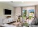 Spacious living area with a gray sectional sofa and large windows at 3468 Dahlia Dr, Lake Hamilton, FL 33851