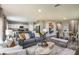 Open living area with gray sofa, white chairs, and a wooden coffee table at 3468 Dahlia Dr, Lake Hamilton, FL 33851