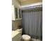 Clean bathroom with black and white checkered shower curtain at 1268 Cr 436, Lake Panasoffkee, FL 33538