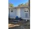 Gray house exterior with white door and landscaping at 1268 Cr 436, Lake Panasoffkee, FL 33538