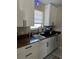 White cabinets and countertops, featuring a modern sink at 1268 Cr 436, Lake Panasoffkee, FL 33538