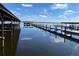 Several wooden docks extend over calm lake water, offering scenic views and water access at 1268 Cr 436, Lake Panasoffkee, FL 33538