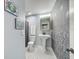 Bathroom with pedestal sink, black and white tile floor, and patterned wall at 2019 Dixie Belle Dr # 2019X, Orlando, FL 32812