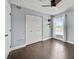 Bright bedroom with double doors, dark hardwood floors, and a window with curtains at 2019 Dixie Belle Dr # 2019X, Orlando, FL 32812