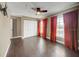 Bedroom with wood floors, orange curtains and ceiling fan at 2019 Dixie Belle Dr # 2019X, Orlando, FL 32812