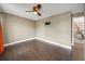 Simple bedroom with wood floors, ceiling fan and wall-mounted TV at 2019 Dixie Belle Dr # 2019X, Orlando, FL 32812