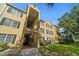 Condo building exterior, featuring a staircase and landscaping at 2019 Dixie Belle Dr # 2019X, Orlando, FL 32812