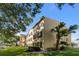 Multi-story building with yellow exterior and landscaping at 2019 Dixie Belle Dr # 2019X, Orlando, FL 32812