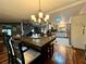 Dining area with dark wood table, chandelier, and kitchen view at 3109 Sand Trap Ct, Lakeland, FL 33810