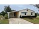 Single-story house with carport and neatly landscaped yard at 3109 Sand Trap Ct, Lakeland, FL 33810