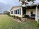 Side view of a ranch home with neat landscaping at 3109 Sand Trap Ct, Lakeland, FL 33810