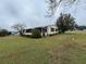 Single-story home with screened porch and green lawn at 3109 Sand Trap Ct, Lakeland, FL 33810