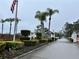 Gated entrance to a community with palm trees and landscaping at 3109 Sand Trap Ct, Lakeland, FL 33810