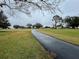 Pathway meandering through a beautifully landscaped golf course at 3109 Sand Trap Ct, Lakeland, FL 33810