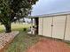 Storage shed and brick patio nestled near a tree at 3109 Sand Trap Ct, Lakeland, FL 33810