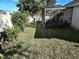 Large backyard with screened enclosure and lawn at 619 Parakeet Ct, Kissimmee, FL 34759