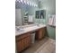 Double vanity bathroom with large mirror and light fixtures at 619 Parakeet Ct, Kissimmee, FL 34759