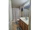 Bathroom with tub shower, vanity, and butterfly theme at 619 Parakeet Ct, Kissimmee, FL 34759