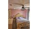 Main bedroom with ornate bed and ceiling fan at 619 Parakeet Ct, Kissimmee, FL 34759