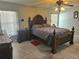 Primary bedroom with large bed, nightstands, and ceiling fan at 619 Parakeet Ct, Kissimmee, FL 34759