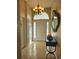Bright entryway with a chandelier, mirror, and tile flooring at 619 Parakeet Ct, Kissimmee, FL 34759
