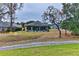 View of the backyard with a screened-in pool and patio area at 706 Lake Diamond Ave, Ocala, FL 34472