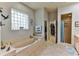 Relaxing bathroom with a large soaking tub and walk-in shower at 706 Lake Diamond Ave, Ocala, FL 34472