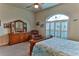 Cozy bedroom with a queen-size bed and dresser at 706 Lake Diamond Ave, Ocala, FL 34472