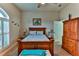 Bright bedroom with wood furniture and plantation shutters at 706 Lake Diamond Ave, Ocala, FL 34472