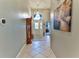Elegant entryway with tile flooring and large artwork at 706 Lake Diamond Ave, Ocala, FL 34472