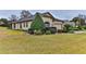 House exterior showcasing landscaping and a partial view of the garage at 706 Lake Diamond Ave, Ocala, FL 34472