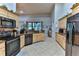 Open concept kitchen with island, stainless steel appliances, and granite countertops at 706 Lake Diamond Ave, Ocala, FL 34472