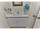 Laundry room with utility sink and ample storage at 706 Lake Diamond Ave, Ocala, FL 34472