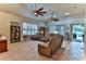 Bright living room with high ceilings and two ceiling fans at 706 Lake Diamond Ave, Ocala, FL 34472