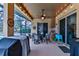 Covered patio with seating and string lights at 706 Lake Diamond Ave, Ocala, FL 34472