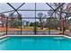 Inviting screened pool area with expansive backyard views at 706 Lake Diamond Ave, Ocala, FL 34472