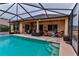 Relaxing pool and patio area with covered lanai and seating at 706 Lake Diamond Ave, Ocala, FL 34472