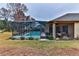 Screened-in pool area with patio furniture and a covered lanai at 706 Lake Diamond Ave, Ocala, FL 34472