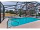 Refreshing screened pool with a view of lush landscaping at 706 Lake Diamond Ave, Ocala, FL 34472