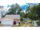 Cute one-story house with a white garage door and red plants at 1100 Lowry Ave # 7, Lakeland, FL 33801