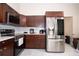 Modern kitchen with stainless steel appliances and wood cabinets at 1100 Lowry Ave # 7, Lakeland, FL 33801